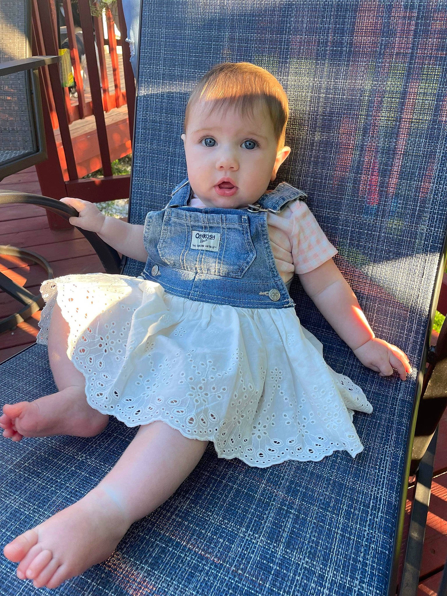 Elizabeth is registered to the contest to win money with this photo: baby_toddler_clothing, chair, child, day_dress, dress, embellishment, face, fashion_design, human_body, iris, joint, leg, person, pink, ruffle, skin, sleeve, sock, surprise, thigh