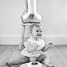 Gianna is registered to the contest to win money with this photo: baby, child, birthday, cake, cake_smash, smiling, laughing, frosting, dessert, balloon, indoor, floor, wooden_floor, stool, sitting, portrait, black_and_white, celebration, party, happy