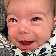 Amelia joined the competition — help win amazing prizes! baby, smiling, close_up, face, infant, joyful, eyes, mouth_open, clothing, pattern, fabric, skin, cute, happy, child, newborn, person, head, cheeks, expression