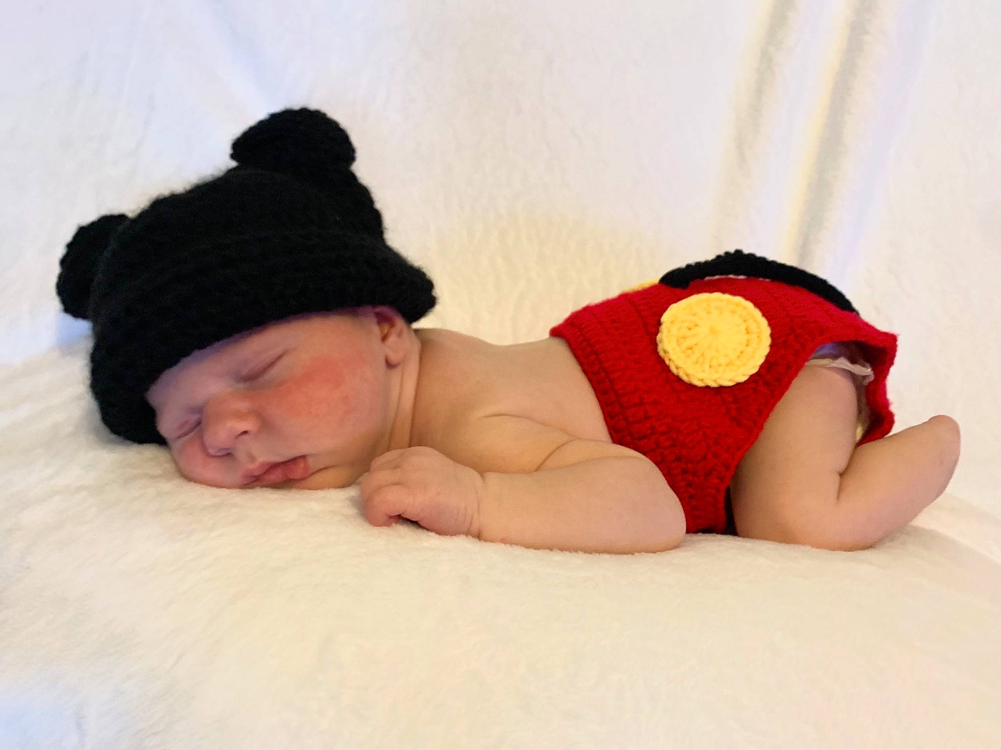 Boston is registered to the contest to win money with this photo: art, baby, baby_sleeping, baby_toddler_clothing, barefoot, comfort, fashion_accessory, foot, hand, headgear, headwear, human_body, human_leg, knee, linens, pattern, person, sitting, skin, thigh