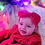 baby, child, smile, red_clothing, headband, bow, face, portrait, closeup, happy, indoors, infant, cute, fashion, apparel, colorful, bokeh, holiday, warm, soft