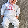 baby, infant, smiling, hoodie, beanie, sweatpants, sock, carpet, floor, casual_clothing, child, cute, happy, portrait, indoor, young_child, person, fashion, relaxed, lying_down