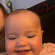 Nova joined the competition — help win amazing prizes! baby, smile, face, child, pink_clothing, indoor, portrait, happy, toy, knitted, closeup, infant, cozy, person, furniture, pillow, warm, cute, young_child, head