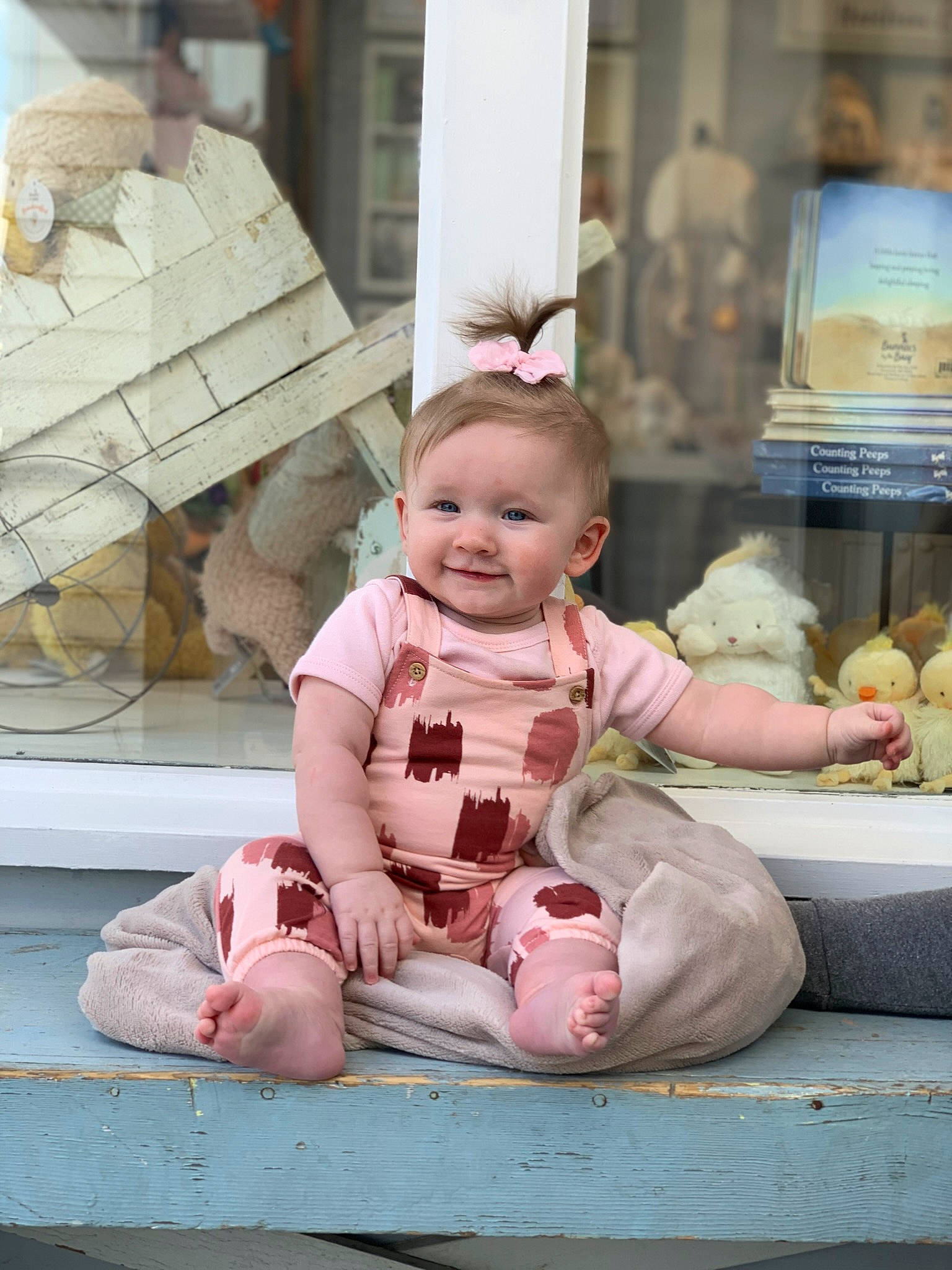 Bailey is registered to the contest to win money with this photo: baby, baby_toddler_clothing, barefoot, cheek, child, flooring, foot, fun, happy, joy, leisure, person, pink, room, sitting, smile, sock, t_shirt, textile, toddler