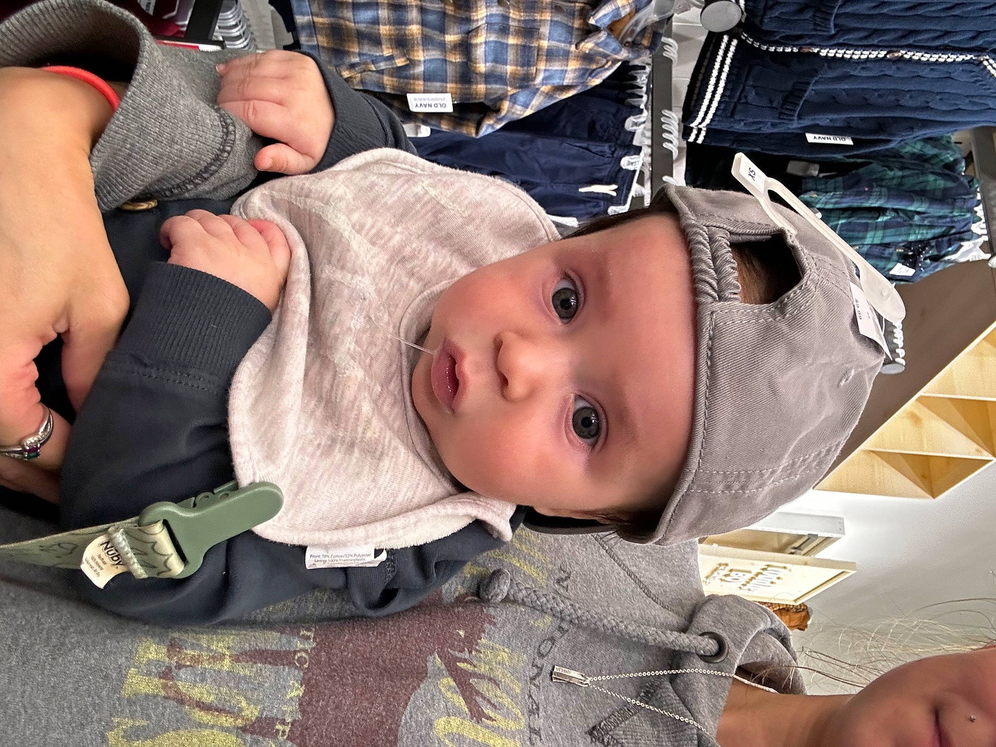 Everett joined the competition — help win amazing prizes! baby, baby_carriage, baby_products, baby_toddler_clothing, cheek, child, comfort, fun, headwear, human_leg, mouth, pattern, person, plaid, product, room, sitting, smile, thigh, toddler