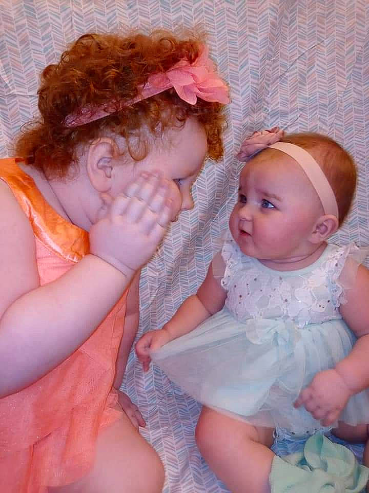 Avah is registered to the contest to win money with this photo: arm, baby, baby_toddler_clothing, bridal_accessory, cheek, child, dress, embellishment, facial_expression, finger, gesture, hand, happy, headpiece, iris, lip, person, pink, skin, textile