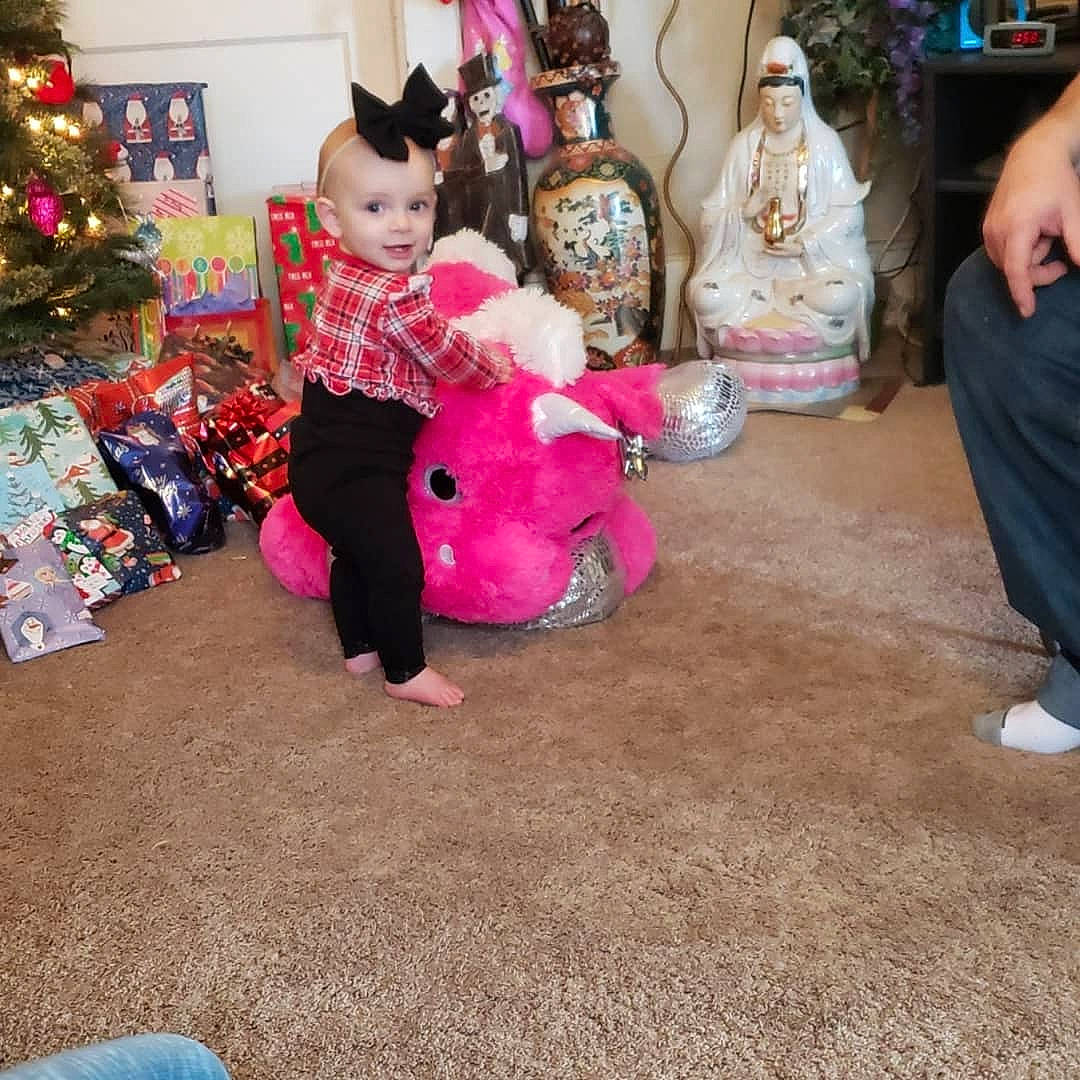 Kyra joined the competition — help win amazing prizes! child, christmas, floor, flooring, fun, head, holiday, lap, leg, person, pink, play, room, sitting, toddler, toy