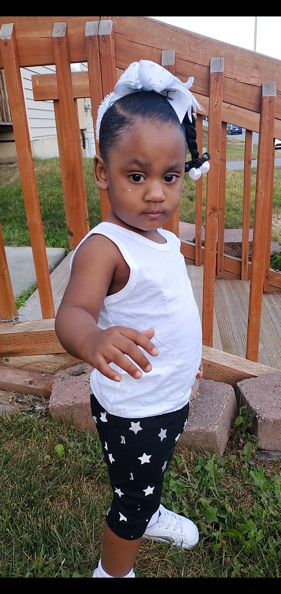 Taeanna is registered to the contest to win money with this photo: active_pants, baby_toddler_clothing, black_hair, child, chin, face, grass, hairstyle, head, knee, neck, pattern, person, plant, sleeve, sportswear, t_shirt, thigh, trunk, waist