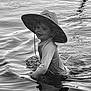 Whitley is registered to the contest to win money with this photo: child, water, hat, splashing, reflection, black_and_white, outdoor, play, smile, nature, lake, ripples, person, young, fun, sun_hat, water_surface, summer, happy, casual_clothing