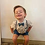 Whitley is registered to the contest to win money with this photo: child, boy, smiling, bow_tie, suspenders, shorts, shoes, socks, carpet, wall, indoor, portrait, happy, cute, fashion, standing, playful, hands_on_hips, person, casual