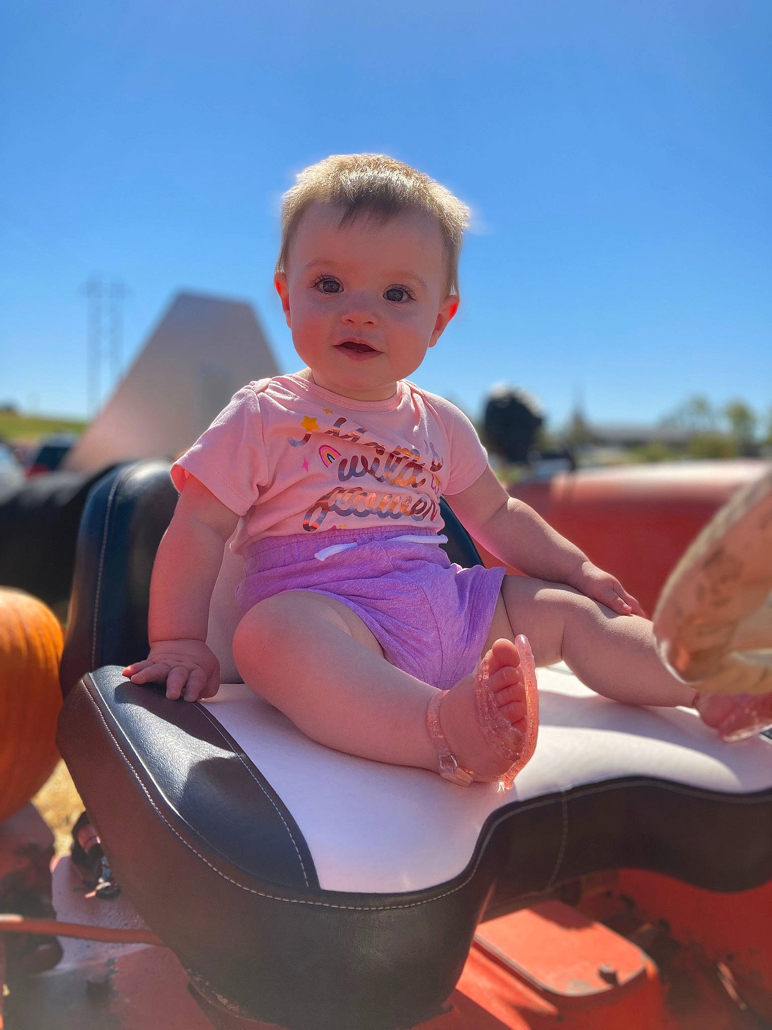 Zavaya is registered to the contest to win money with this photo: baby, baby_toddler_clothing, child, eyewear, facial_expression, fun, hairstyle, happy, lap, leisure, outdoor_play_equipment, person, play, playing_with_kids, recreation, sitting, sky, sunlight, thigh, toddler