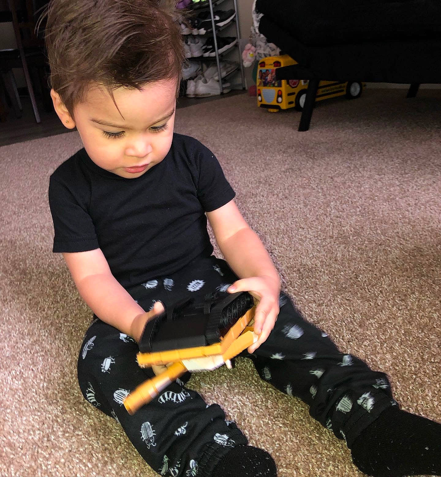 Kareem is registered to the contest to win money with this photo: baby, chair, child, elbow, electric_blue, flooring, fun, human_body, human_leg, joint, knee, machine, person, shoe, sitting, t_shirt, thigh, toddler, toy, toy_vehicle