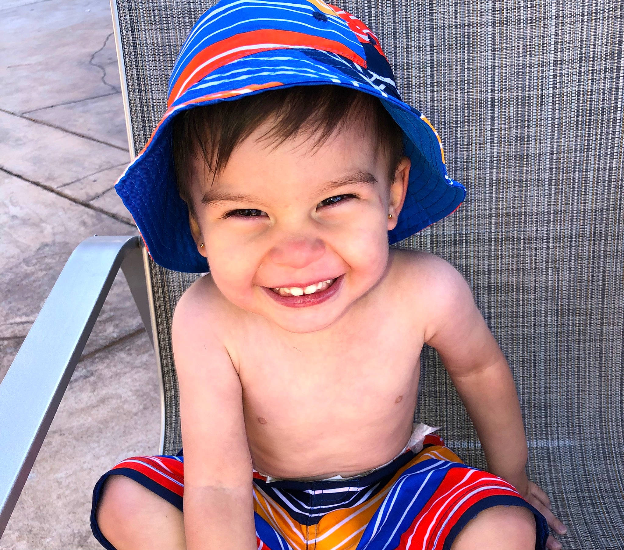 Kareem is registered to the contest to win money with this photo: baby_toddler_clothing, blue, cap, chin, cool, costume_hat, eye, face, fun, hairstyle, happy, hat, head, human_body, joy, lip, neck, nose, person, smile