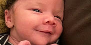 Xophia joined the competition — help win amazing prizes! baby, blanket, closeup, cozy, cushion, cute, expression, face, hands, happy, head, indoors, infant, newborn, person, portrait, skin, smile, striped_clothing, young_child