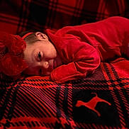 Brelynn joined the competition — help win amazing prizes! baby, child, close_up, cozy, cute, dog_silhouette, face, headband, indoor, infant, lying_down, newborn, pattern, plaid_blanket, portrait, red_bow, red_clothing, sleeping, soft_light, warm_colors