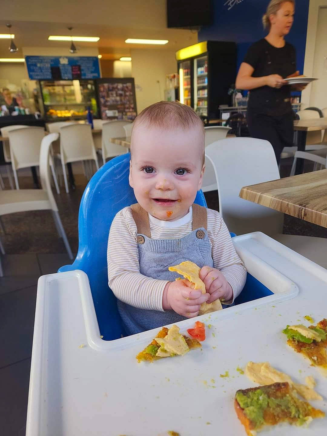 Zuko is registered to the contest to win money with this photo: baby, baby_toddler_clothing, chair, child, comfort_food, cuisine, dish, event, food, fun, happy, joy, person, plate, recipe, sharing, sitting, smile, t_shirt, table