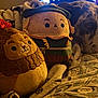 dog, great_dane, plush_toy, stuffed_animal, blanket, bedspread, indoor, resting, sleepy, cozy, fabric, pattern, soft_toy, animal, pet, home, relaxing, comfort, warm_lighting, snuggle