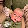 Leo is registered to the contest to win money with this photo: arm, baby, blanket, casual, closeup, clothing, comfort, couch, expression, face, holding, home, indoor, infant, mittens, person, portrait, relaxation, skin, young_child