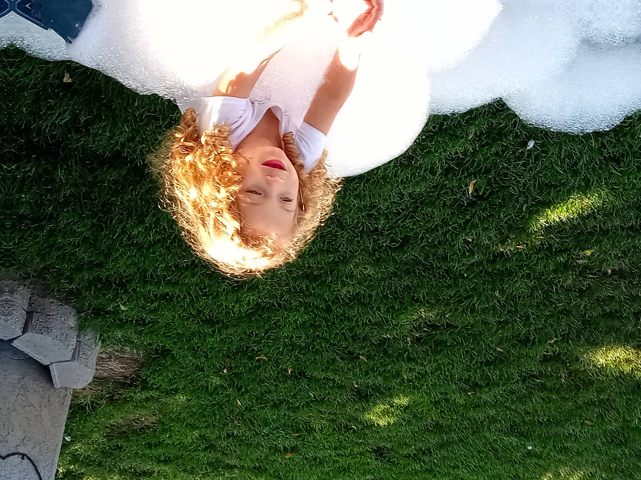 Winnie Dewann is registered to the contest to win money with this photo: backlighting, dress, flash_photography, fun, gesture, grass, grassland, happy, human_leg, landscape, lawn, leisure, meadow, people_in_nature, person, petal, plant, shadow, shrub, sky