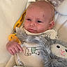 Waylon is registered to the contest to win money with this photo: baby, baby_boy, baby_girl, child, clothing, comfort, cushion, cute, face, hand, indoors, infant, lying_down, pacifier, plush_toy, portrait, relaxed, sleeping_bag, soft_toy, stuffed_animal