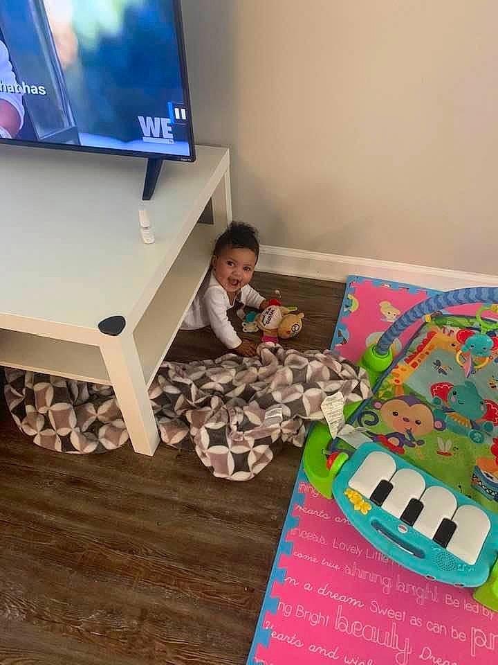 Mckenna is registered to the contest to win money with this photo: child, electronic_device, floor, flooring, furniture, person, play, room, table, technology, toddler