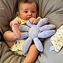 Milo a rejoint le concours — aidez-le/la à gagner de superbes lots ! baby, infant, plush_toy, octopus, cushion, chair, blanket, foot, hand, cute, soft_toy, comfort, relaxation, indoors, child, person, clothing, expression, skin, baby_clothes