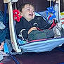 Gabriel participe au concours pour gagner de l'argent avec cette photo : baby, blue, child, clothing, comfort, cushion, face, happy, indoor, laughing, person, plastic, play, red, seat, smile, socks, swing, toddler, toy