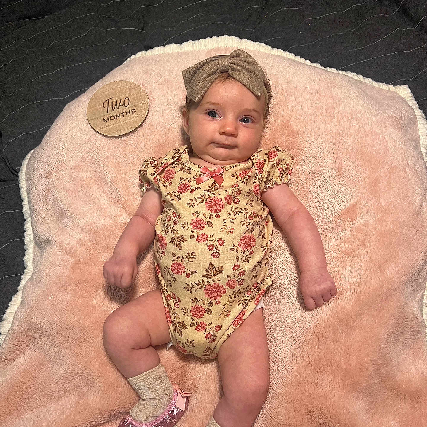 Leyana joined the competition — help win amazing prizes! baby, blanket, bow, child, cute, face, floral, headband, indoor, infant, lying_down, newborn, onesie, person, pink, portrait, shoe, small, sock, soft_texture