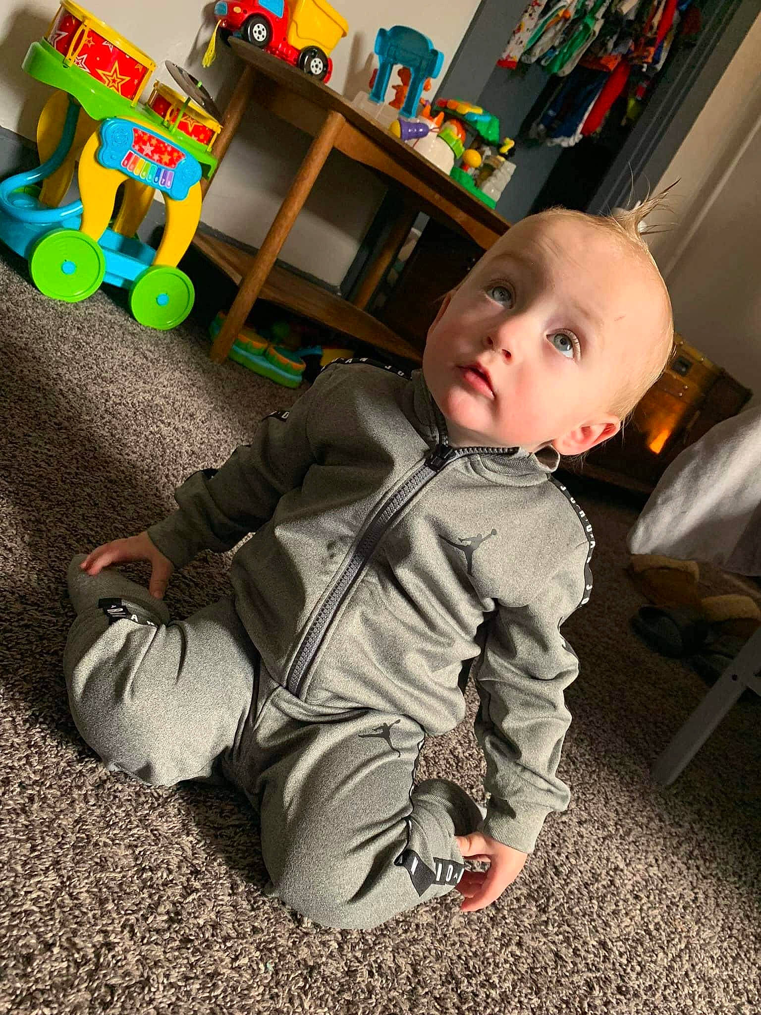 Lyric is registered to the contest to win money with this photo: baby, baby_products, baby_toddler_clothing, chair, child, comfort, flooring, fun, lap, leg, person, play, product, room, shelf, sitting, standing, stuffed_toy, surprise, toddler