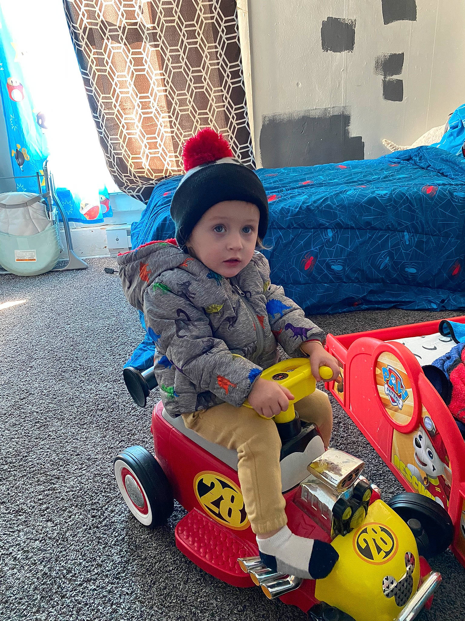 Lyric is registered to the contest to win money with this photo: baby, baby_products, baby_toddler_clothing, blue, child, fun, green, headwear, leisure, person, play, racing, recreation, riding_toy, sitting, tire, toddler, toy, toy_vehicle, travel