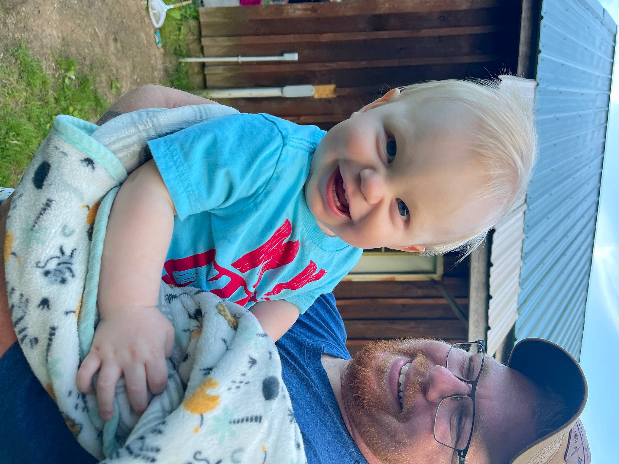 Ira is registered to the contest to win money with this photo: baby, baby_toddler_clothing, child, eye, face, facial_expression, glasses, grass, hairstyle, happy, iris, joy, mouth, nose, person, plant, skin, smile, toddler, tree