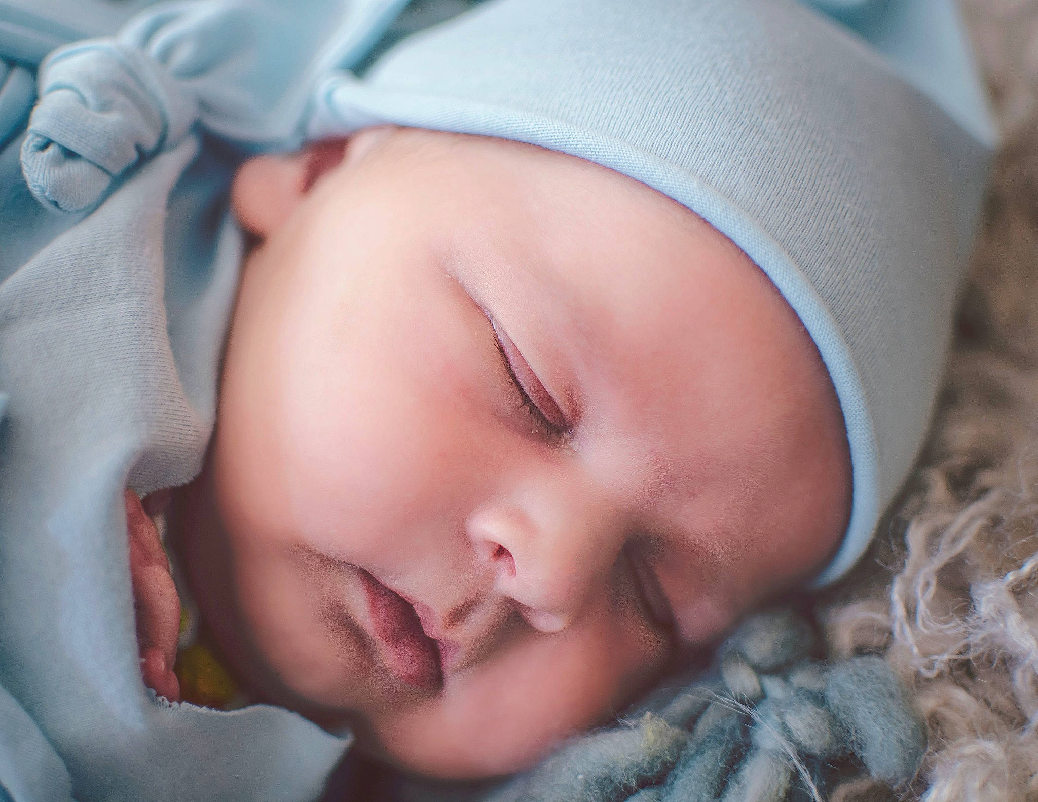 Bonham is registered to the contest to win money with this photo: baby, baby_sleeping, cheek, comfort, eye, face, facial_expression, finger, gesture, grass, hand, head, headwear, human, human_body, iris, lip, mouth, nose, person