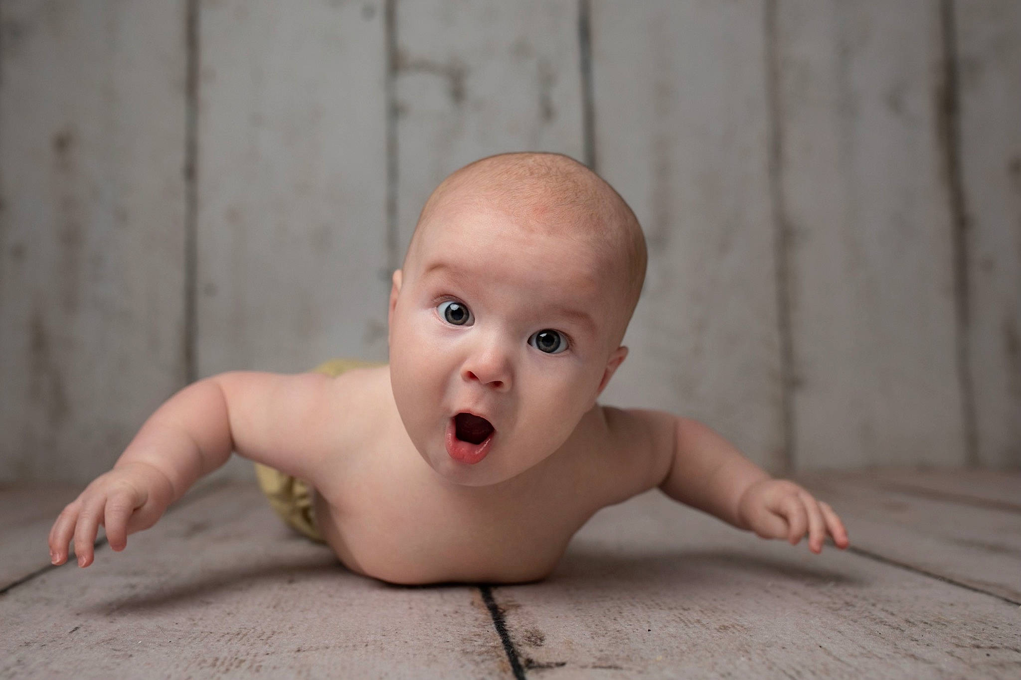 Trulee is registered to the contest to win money with this photo: baby, baby_crawling, cheek, chest, crawling, eye, eyebrow, eyelash, flash_photography, floor, flooring, foot, happy, hardwood, human_body, iris, lip, person, snout, surprise