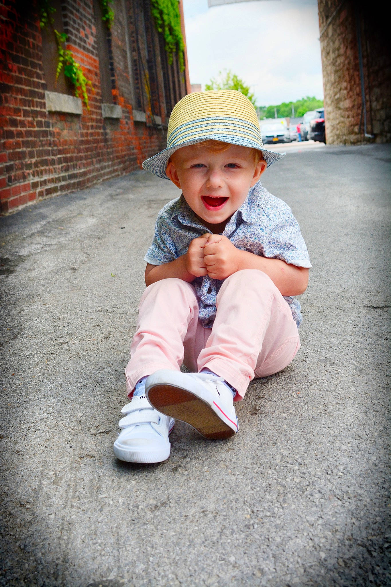 Sylar is registered to the contest to win money with this photo: asphalt, baby, cap, child, flash_photography, grass, happy, hat, headwear, human_leg, leisure, person, plant, recreation, road_surface, sitting, sky, sleeve, smile, street_fashion