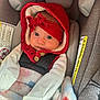 baby, infant, car_seat, red_hood, headband, blanket, straps, cozy, cute, wide_eyes, indoor, child, seatbelt, soft_texture, warm_clothing, portrait, person, newborn, comfortable, closeup
