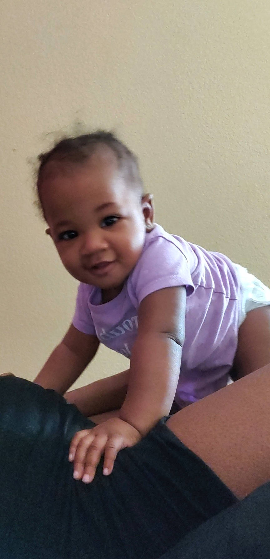 Ashlyn is registered to the contest to win money with this photo: arm, baby, baby_toddler_clothing, cheek, chest, comfort, elbow, flash_photography, flooring, happy, human_leg, iris, joint, knee, person, skin, sleeve, smile, t_shirt, toddler