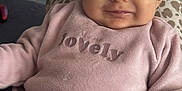 Bianca participe au concours pour gagner de l'argent avec cette photo : baby, child, pink_clothing, smile, face, infant, cushion, pattern, television, indoor, comfort, soft_fabric, closeup, sitting, portrait, cute, young, happy, cozy, home