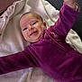 baby, infant, smiling, purple_clothing, blanket, couch, indoor, happy, person, face, head, child, toddler, cozy, soft_texture, lying_down, home, cute, young, comfortable