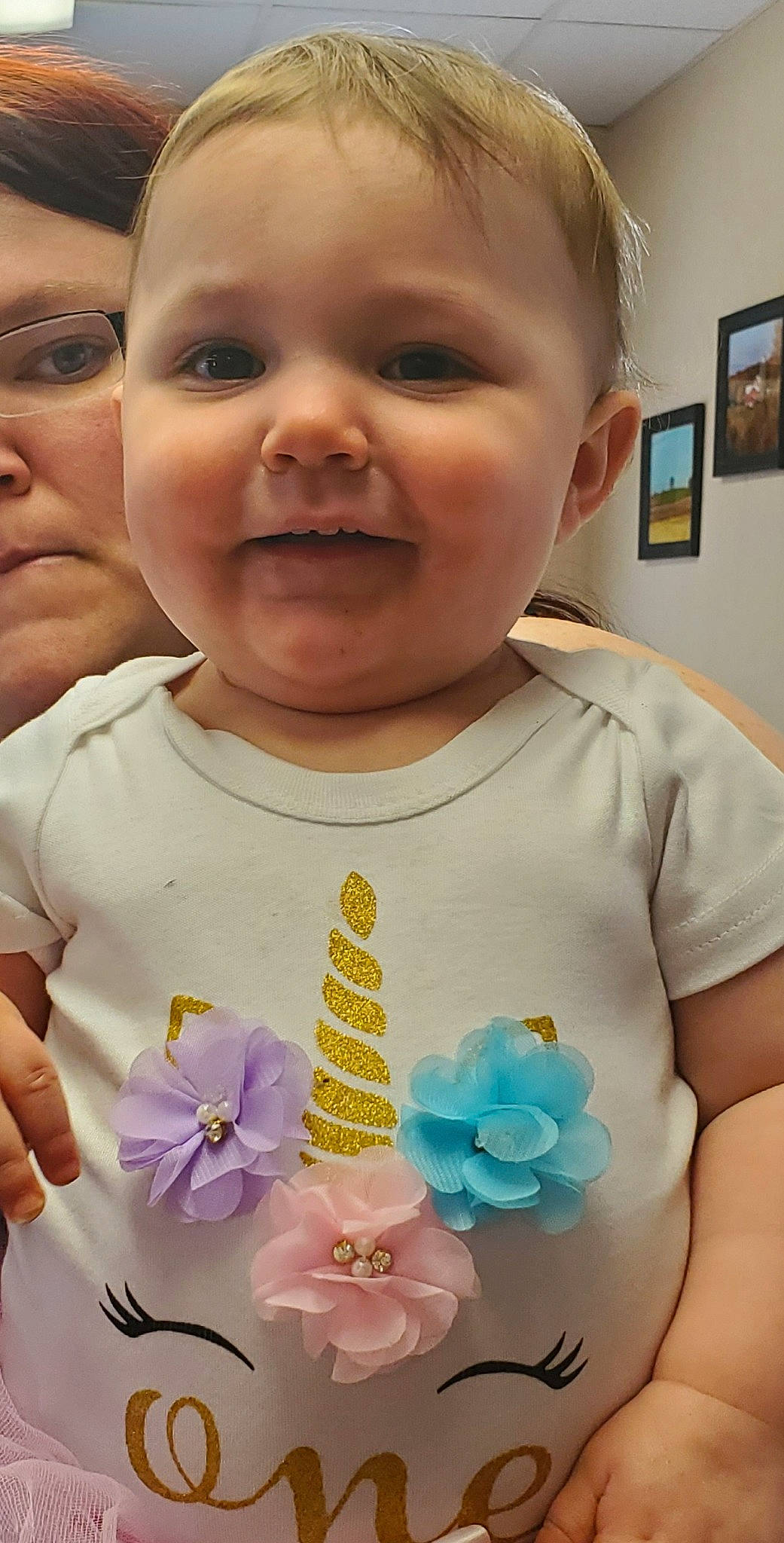 Eleanor is registered to the contest to win money with this photo: baby_toddler_clothing, cheek, chin, cool, dress, eye, eyelash, finger, flower, happy, iris, nose, person, picture_frame, pink, plant, product, skin, sleeve, smile