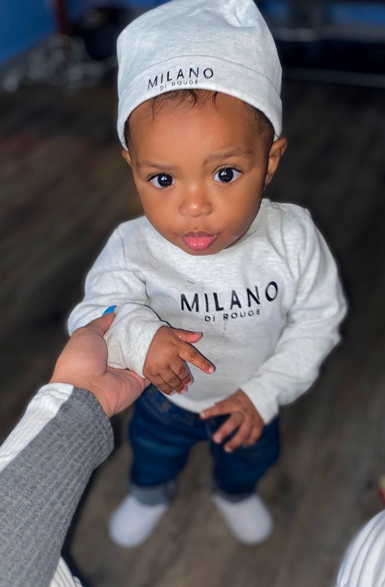 Kenzo is registered to the contest to win money with this photo: baby, baby_toddler_clothing, cap, cheek, child, electric_blue, eye, fashion_accessory, finger, flash_photography, fun, gesture, happy, head, headgear, person, sitting, sleeve, smile, toddler
