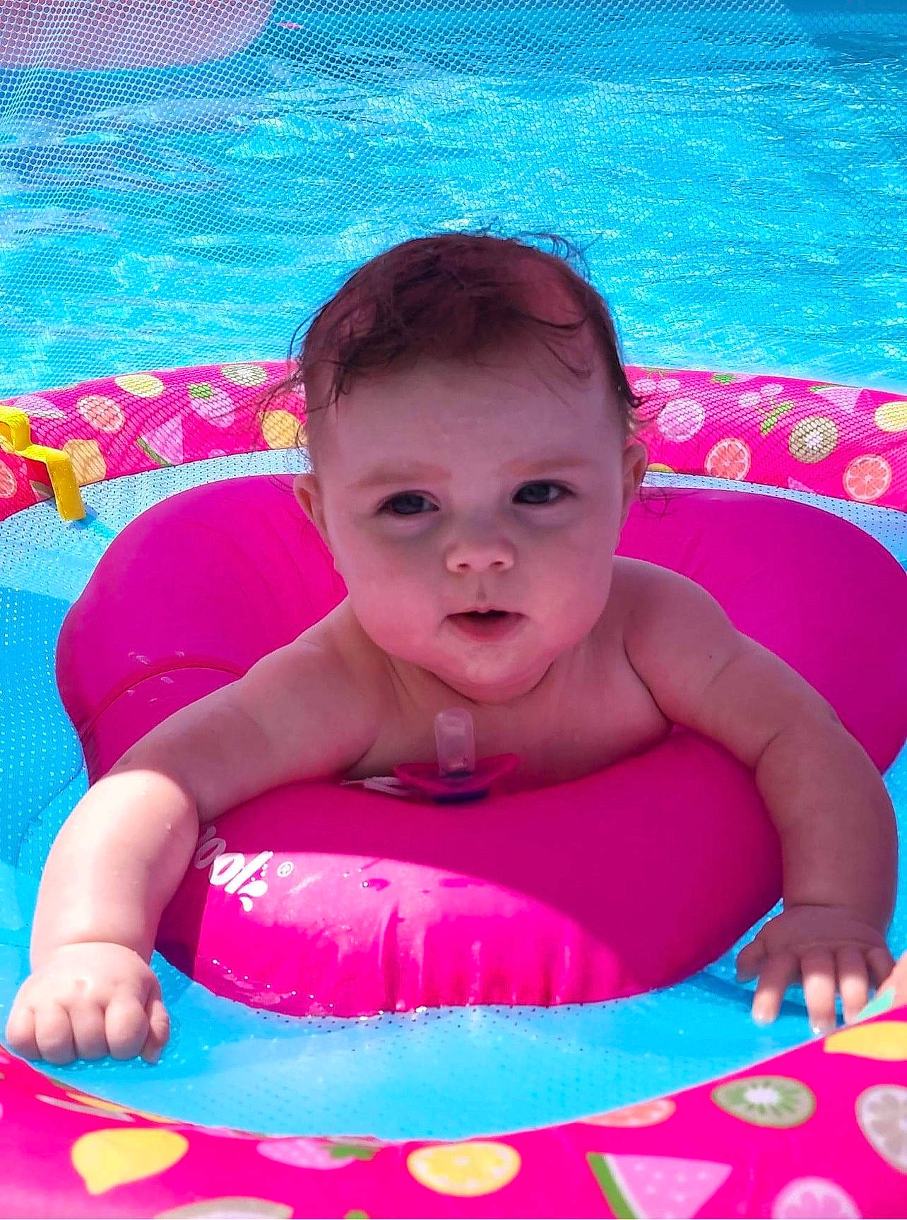 Addalynn is registered to the contest to win money with this photo: aqua, azure, baby, baby_playing_with_toys, baby_toddler_clothing, cheek, child, facial_expression, fun, happy, leisure, magenta, person, pink, product, purple, skin, swimming_pool, toddler, tummy_time