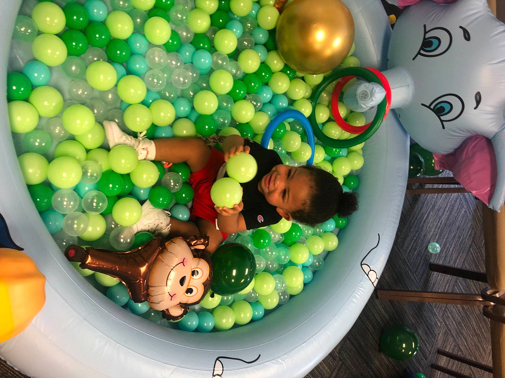 Kristian is registered to the contest to win money with this photo: baby_toys, balloon, circle, event, fun, games, glass, green, joy, kitchen_utensil, party_supply, person, plastic, play, sphere, sweetness, toy