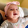 Kylynn joined the competition — help win amazing prizes! baby, child, smiling, headband, pink, bow, face, clothing, long_sleeve, rainbow_pattern, cozy, indoor, person, cute, happy, infant, portrait, soft, comfortable, warm_lighting