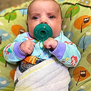 Kylynn joined the competition — help win amazing prizes! baby, pacifier, blanket, pajamas, cushion, owl_pattern, infant, face, hands, blue_eyes, colorful_clothing, indoor, cozy, soft_texture, child, cute, wrapped, lying_down, closeup, portrait