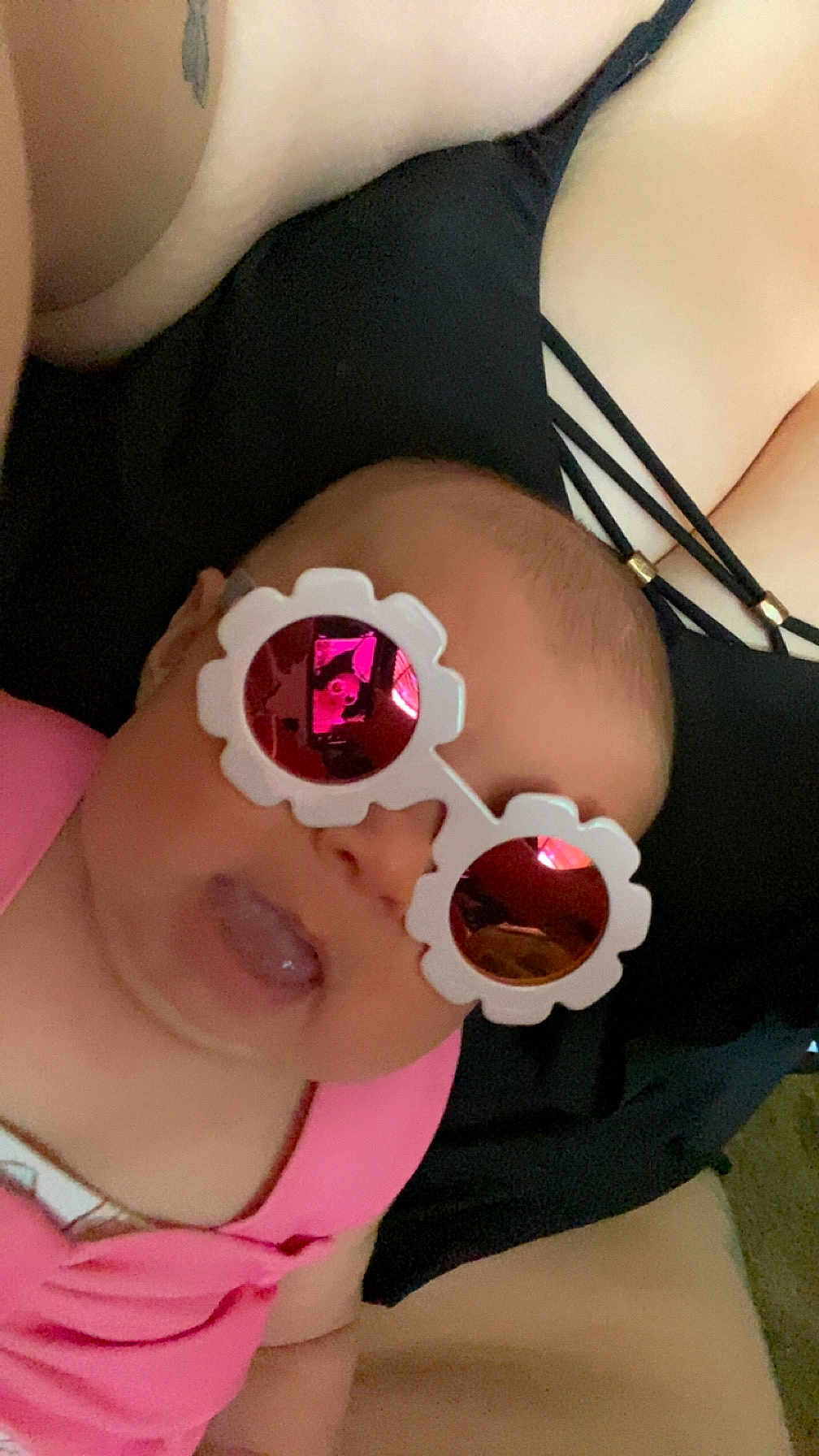 Kylynn joined the competition — help win amazing prizes! baby, sunglasses, pink, tongue_out, reflection, person, clothing, black, straps, face, head, cute, humor, close_up, indoors, skin, child, infant, accessory, wearing