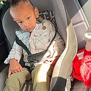 Skyler joined the competition — help win amazing prizes! child, toddler, car_seat, car_interior, seatbelt, plaid_jacket, olive_pants, black_shoes, high_puff_hairstyle, sunlight, window_light, seat, safety, young_child, portrait, casual_clothing, indoor, car, curious_expression, young_person