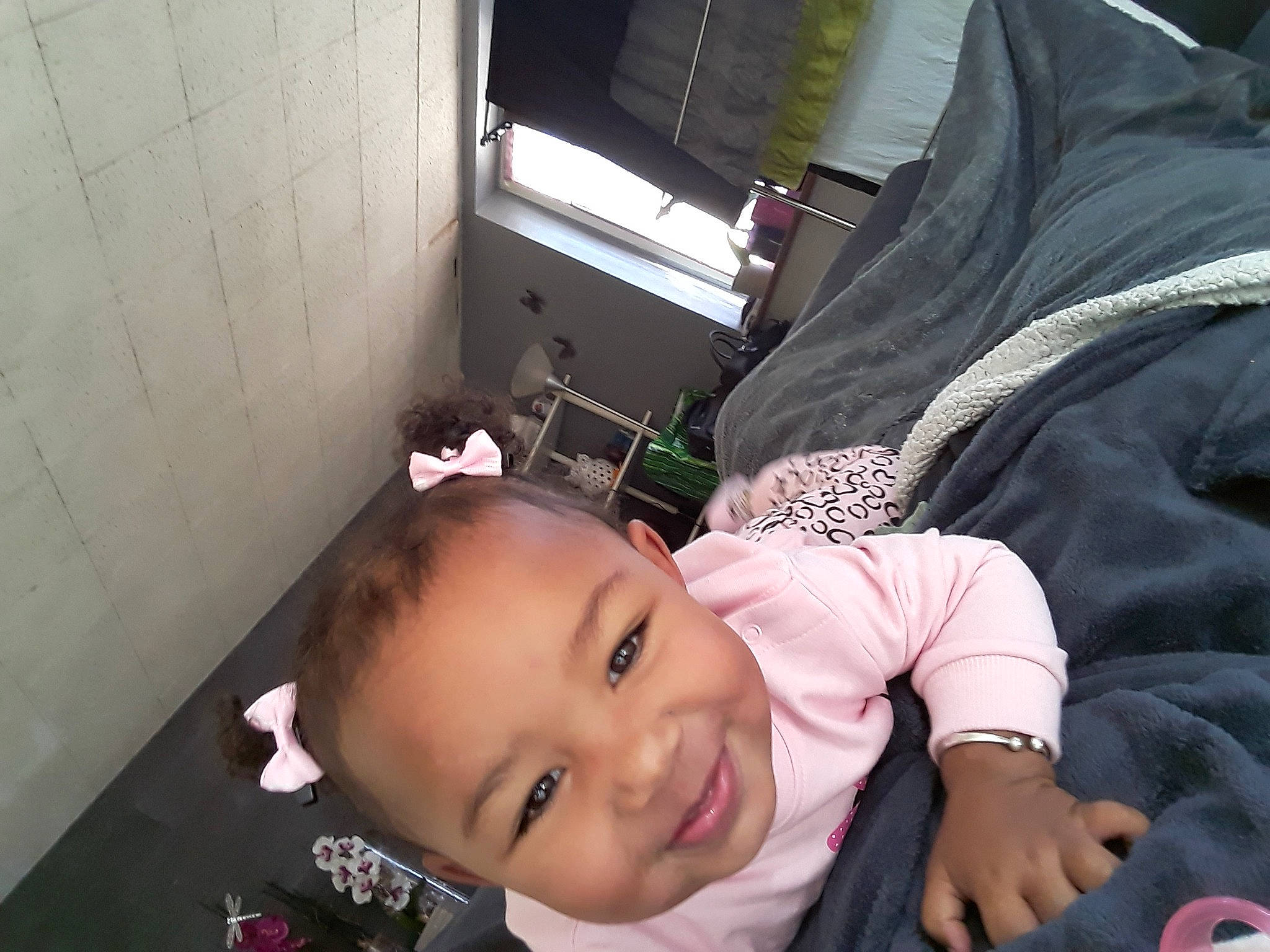 Maïya a rejoint le concours — aidez-le/la à gagner de superbes lots ! baby, baby_products, baby_toddler_clothing, black_hair, cheek, child, comfort, eyelash, fun, hand, happy, head, joy, mouth, nose, person, room, sitting, skin, smile