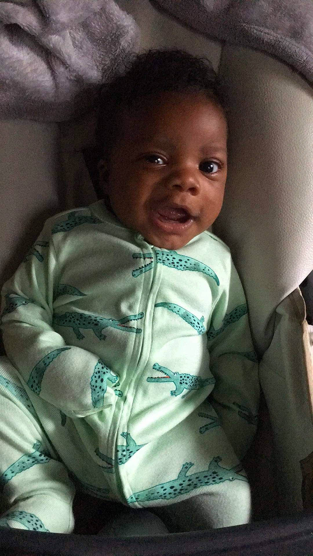 Malaki is registered to the contest to win money with this photo: baby, baby_toddler_clothing, cheek, child, chin, comfort, cool, eyebrow, face, flash_photography, happy, iris, lip, mouth, neck, nose, person, skin, sleeve, smile