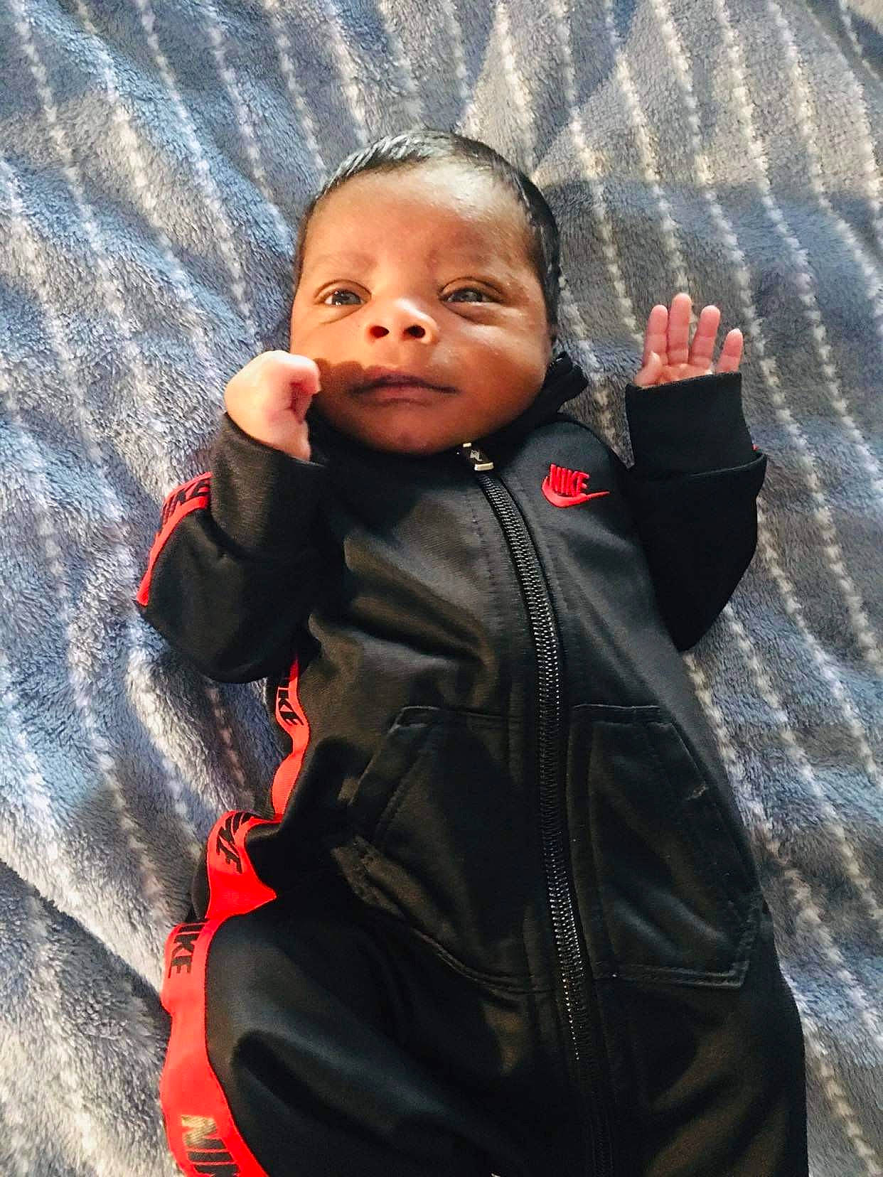 Malaki joined the competition — help win amazing prizes! baby, cheek, eye, finger, flash_photography, formal_wear, gesture, hand, happy, head, human_body, jacket, leather_jacket, lip, nose, outerwear, person, sleeve, smile, thumb