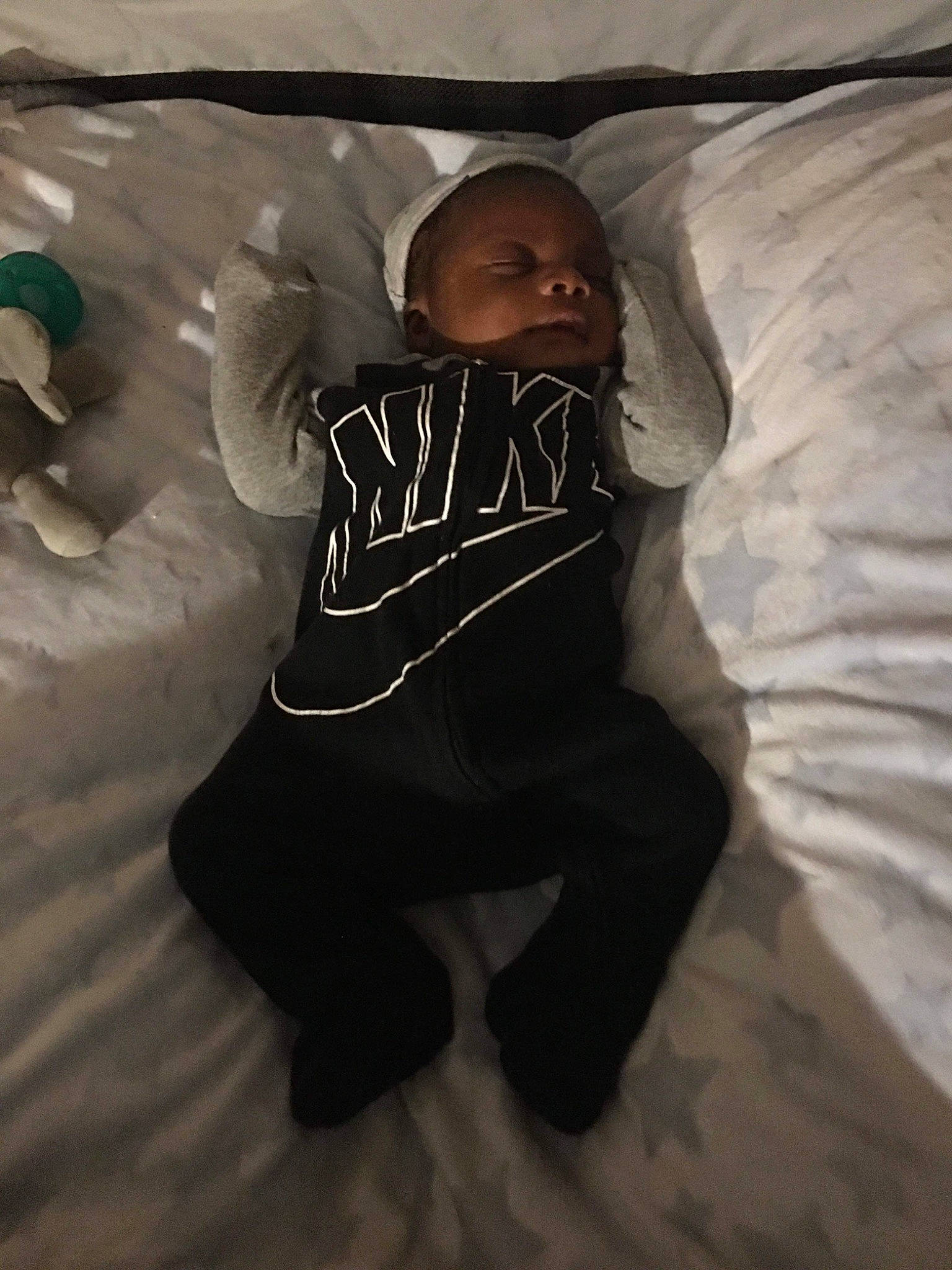 Malaki is registered to the contest to win money with this photo: baby, baby_toddler_clothing, bed, child, comfort, darkness, flash_photography, flooring, font, fun, fur, grey, hoodie, human_body, linens, person, sitting, sleeve, sportswear, t_shirt